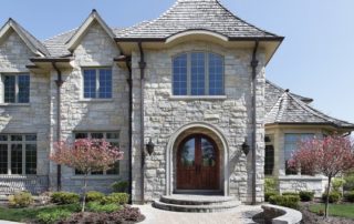 single and double pane windows on a white stone house