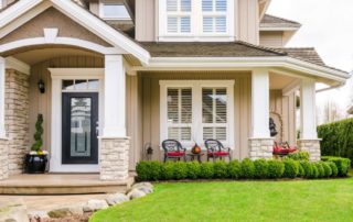 The front of a beige home with stone accents