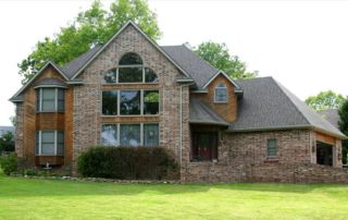 two story home with large single pane windows