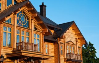 a large wooden house with many windows and balconies