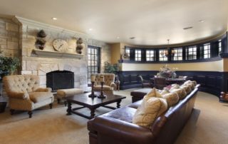 a living room with couches, chairs and a fireplace