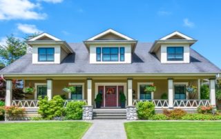 a house with a red front door and green lawn