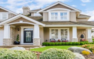 a house with landscaping and shrubs in front of it