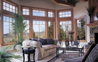 a living room filled with furniture and large windows