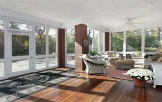 a living room filled with furniture and lots of windows