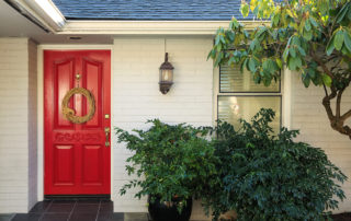 White Brick Front Porch With Red Door