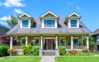 a house with a red front door and two windows