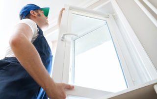 A window technician installing and replacing a window