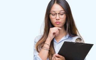 A woman hold a clipboard and looking at it