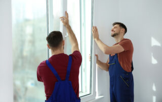 Two workers from Zen Windows replace a window in the Twin Cities.