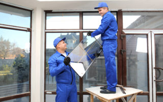 Two workers from Zen Windows Twin Cities install a replacement window